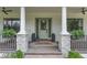 Charming front porch featuring decorative stone, columns, and a stylish front door at 5351 Carson St, St Cloud, FL 34771