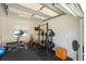 Well-equipped home gym with weightlifting equipment, treadmill, and rubber flooring for a complete fitness experience at 5351 Carson St, St Cloud, FL 34771