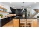 Modern kitchen features black cabinetry, large island with seating, and stainless steel appliances at 5351 Carson St, St Cloud, FL 34771
