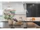 Stylish kitchen featuring a large island, black cabinetry, and sleek white hood vent at 5351 Carson St, St Cloud, FL 34771