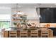 Bright kitchen island with seating, pendant lights, open shelving, and stylish decor at 5351 Carson St, St Cloud, FL 34771