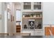 Modern kitchen with stainless steel espresso maker, floating shelves, and custom cabinets at 5351 Carson St, St Cloud, FL 34771