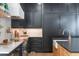 The kitchen has ample storage, modern stainless appliances, and marble backsplash at 5351 Carson St, St Cloud, FL 34771