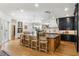 Spacious kitchen featuring a large center island, modern lighting, and hardwood floors throughout the area at 5351 Carson St, St Cloud, FL 34771