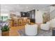 Bright kitchen featuring a large island with seating, modern cabinetry, and hardwood floors at 5351 Carson St, St Cloud, FL 34771