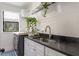 Modern laundry room with a large sink, dark countertop, and plenty of storage space at 5351 Carson St, St Cloud, FL 34771