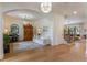 Bright open-concept living room featuring wood floors, an arched entrance, and a view of the staircase at 5351 Carson St, St Cloud, FL 34771
