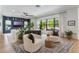 Spacious living room featuring built-in shelving, large windows with outdoor views, and modern furnishings at 5351 Carson St, St Cloud, FL 34771