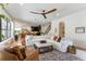 Open-concept living room featuring a plush white sofa, stylish decor, and view of a modern kitchen at 5351 Carson St, St Cloud, FL 34771