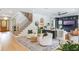 Bright and airy living room featuring hardwood floors, a staircase, and stylish furnishings at 5351 Carson St, St Cloud, FL 34771