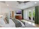 Serene main bedroom featuring a TV, balcony access, and modern decor, perfect for relaxing after a long day at 5351 Carson St, St Cloud, FL 34771