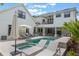 A well-designed pool area with a spa, sun loungers, and an umbrella offers a luxurious outdoor retreat at 5351 Carson St, St Cloud, FL 34771