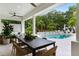 Stunning outdoor pool area with a waterfall feature, lush landscaping, and ample seating for relaxation and entertainment at 5351 Carson St, St Cloud, FL 34771