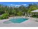 Inviting backyard pool and spa area with tiled surround and lush landscaping, ideal for outdoor relaxation at 5351 Carson St, St Cloud, FL 34771