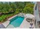 Aerial view of a pristine pool and spa surrounded by manicured landscaping and patio seating at 5351 Carson St, St Cloud, FL 34771