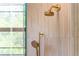 Detailed view of the shower fixtures with brushed gold finish and decorative tile surround at 5351 Carson St, St Cloud, FL 34771