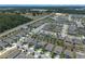 An aerial view displays the well-planned neighborhood with uniform homes, tree-lined streets, and community layout at 5515 Palomino Pl, Apopka, FL 32712