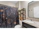 Stylish bathroom featuring patterned shower curtain, granite vanity, and modern shelf at 5515 Palomino Pl, Apopka, FL 32712