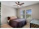Cozy bedroom with a ceiling fan, large window, and neutral decor at 5515 Palomino Pl, Apopka, FL 32712