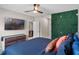 Well-lit bedroom with a statement wall and access to an ensuite bathroom and living space at 5515 Palomino Pl, Apopka, FL 32712
