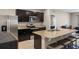 Modern kitchen with dark cabinetry, stainless steel appliances, and a large center island at 5515 Palomino Pl, Apopka, FL 32712