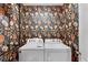 Laundry room showcasing floral wallpaper and white front load washer and dryer units at 5515 Palomino Pl, Apopka, FL 32712