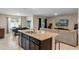 Open-concept living space featuring a spacious kitchen island and a comfortable living area at 5515 Palomino Pl, Apopka, FL 32712