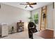Home office featuring a ceiling fan, large window, and stylish decor at 5515 Palomino Pl, Apopka, FL 32712