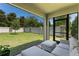Screened-in patio with a view of the fenced backyard and outdoor seating at 5515 Palomino Pl, Apopka, FL 32712
