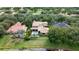 Aerial view of home and pool surrounded by mature trees in desirable neighborhood at 6149 Blakeford Dr, Windermere, FL 34786