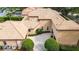 Aerial view of a tile roof home with a pool, mature landscaping, and portico at 6149 Blakeford Dr, Windermere, FL 34786