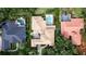 Aerial view of tile roof home with swimming pool, landscaping, and mature trees at 6149 Blakeford Dr, Windermere, FL 34786