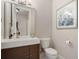 Modern half bathroom featuring sleek vanity with light countertop and contemporary fixtures at 6149 Blakeford Dr, Windermere, FL 34786