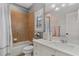 Bathroom with neutral-colored backsplash, white cabinets, sink, and toilet at 6149 Blakeford Dr, Windermere, FL 34786
