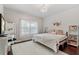 Bright bedroom features a chandelier, a large window, and an accent wall at 6149 Blakeford Dr, Windermere, FL 34786