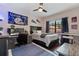 Bedroom with desk, blue rug, sports flags, and a fan at 6149 Blakeford Dr, Windermere, FL 34786
