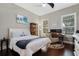 Bright bedroom with hardwood floors, two windows, a ceiling fan, and a desk at 6149 Blakeford Dr, Windermere, FL 34786