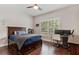 Bedroom with hardwood floors and a window with plantation shutters at 6149 Blakeford Dr, Windermere, FL 34786