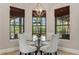 Bright dining area featuring a glass table, comfortable seating, and large windows at 6149 Blakeford Dr, Windermere, FL 34786