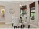 Dining area boasts a glass table, upholstered seating, a modern chandelier, and window views at 6149 Blakeford Dr, Windermere, FL 34786