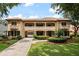 Charming two-story home featuring a tile roof, balcony, portico, and manicured front lawn at 6149 Blakeford Dr, Windermere, FL 34786