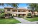 Stately home with tile roof, large windows, manicured landscaping, and covered entry at 6149 Blakeford Dr, Windermere, FL 34786