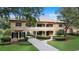 Charming exterior with tile roof, balcony and green lawn framed by mature trees at 6149 Blakeford Dr, Windermere, FL 34786