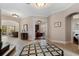 Elegant foyer features decorative tiled flooring and archways leading to the living spaces and office at 6149 Blakeford Dr, Windermere, FL 34786