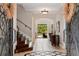 Elegant foyer with tile flooring, staircase, wrought iron door, and views of backyard at 6149 Blakeford Dr, Windermere, FL 34786
