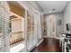 Hallway with access to the outdoor patio and bathroom, featuring hardwood floors and natural light at 6149 Blakeford Dr, Windermere, FL 34786