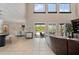 Open floor plan featuring a living room with pool access, high ceilings, and an entertainment center at 6149 Blakeford Dr, Windermere, FL 34786