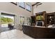 Comfortable living room boasts fireplace, high ceilings, an entertainment center, and backyard access at 6149 Blakeford Dr, Windermere, FL 34786