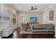 Cozy living room with a ceiling fan, hardwood floors, and ample natural light at 6149 Blakeford Dr, Windermere, FL 34786