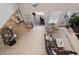 Open-concept living room featuring tile floors, leather sofa, and seamless access to the outdoor patio at 6149 Blakeford Dr, Windermere, FL 34786